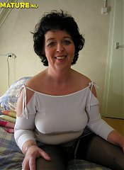 Horny mature slut masturbating on bed